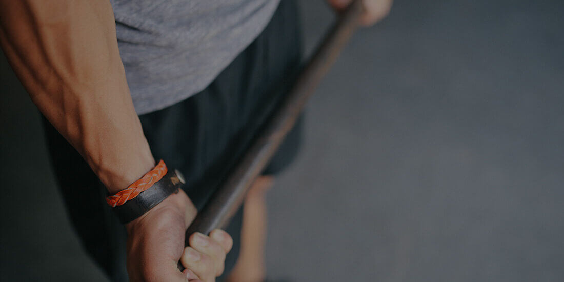 A person holding onto a wooden stick