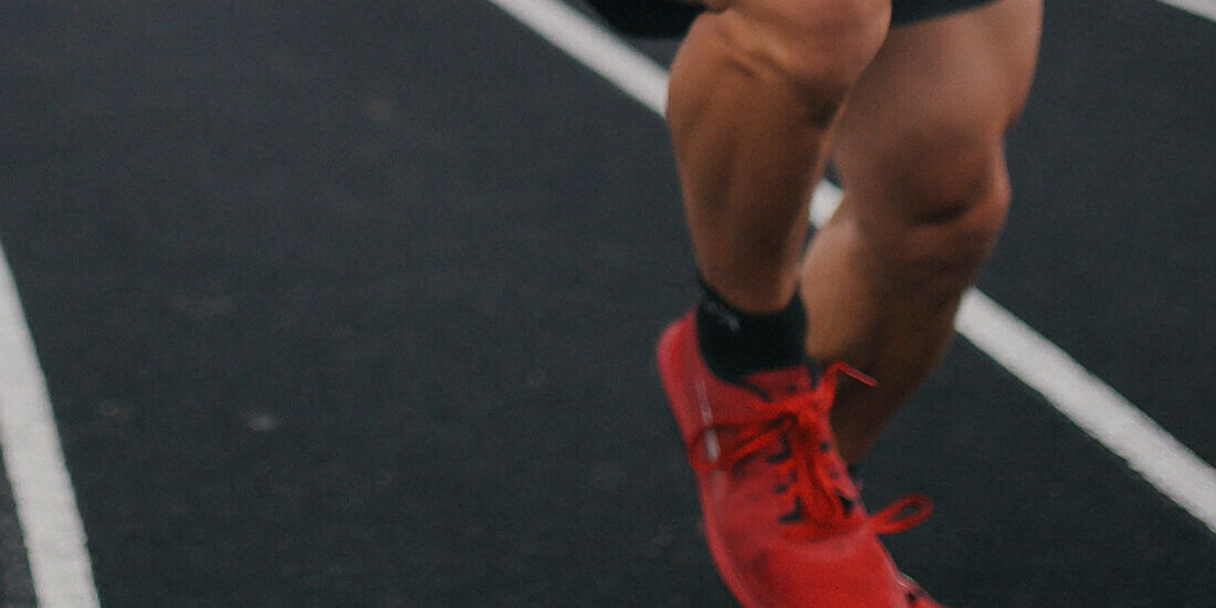 A close up of someone running on the track