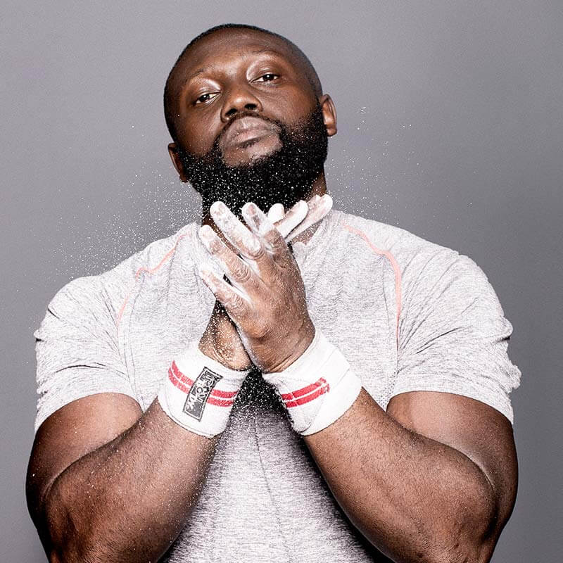 A man with a beard and white shirt is praying