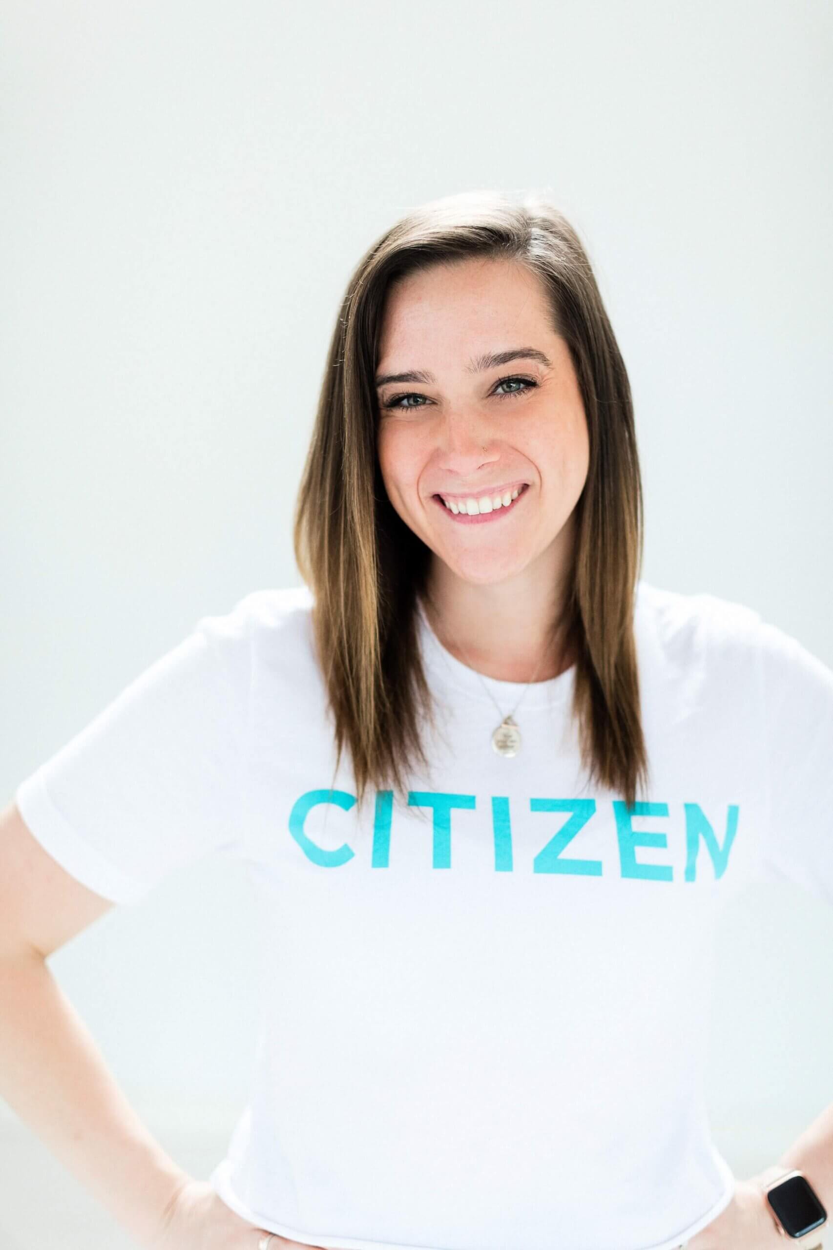 A woman wearing a white citizen t-shirt.