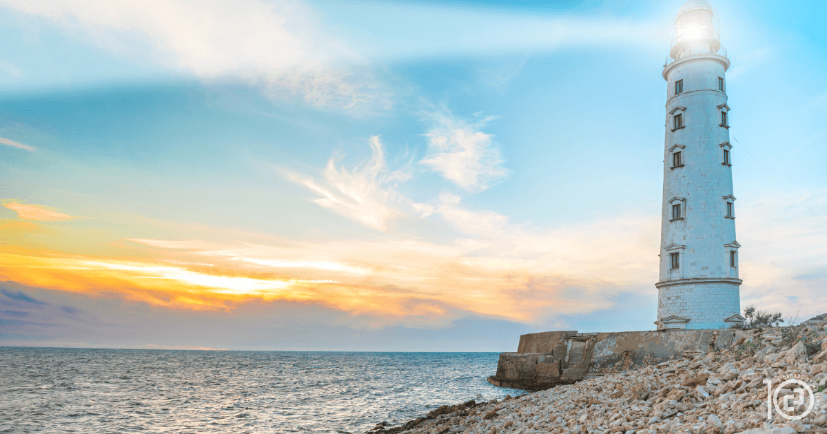 Lighthouse at dusk symbolizing clarity and guidance in leadership, for Citizen Pilates blog “From Bystander to Up-Stander.”
