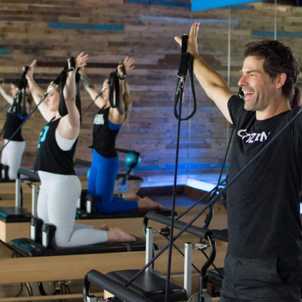 Pilates Instructor Jobs in Houston | Citizen Pilates Reformer Class Men and women training in a reformer Pilates class at Citizen Pilates in Houston, representing instructor-led fitness careers