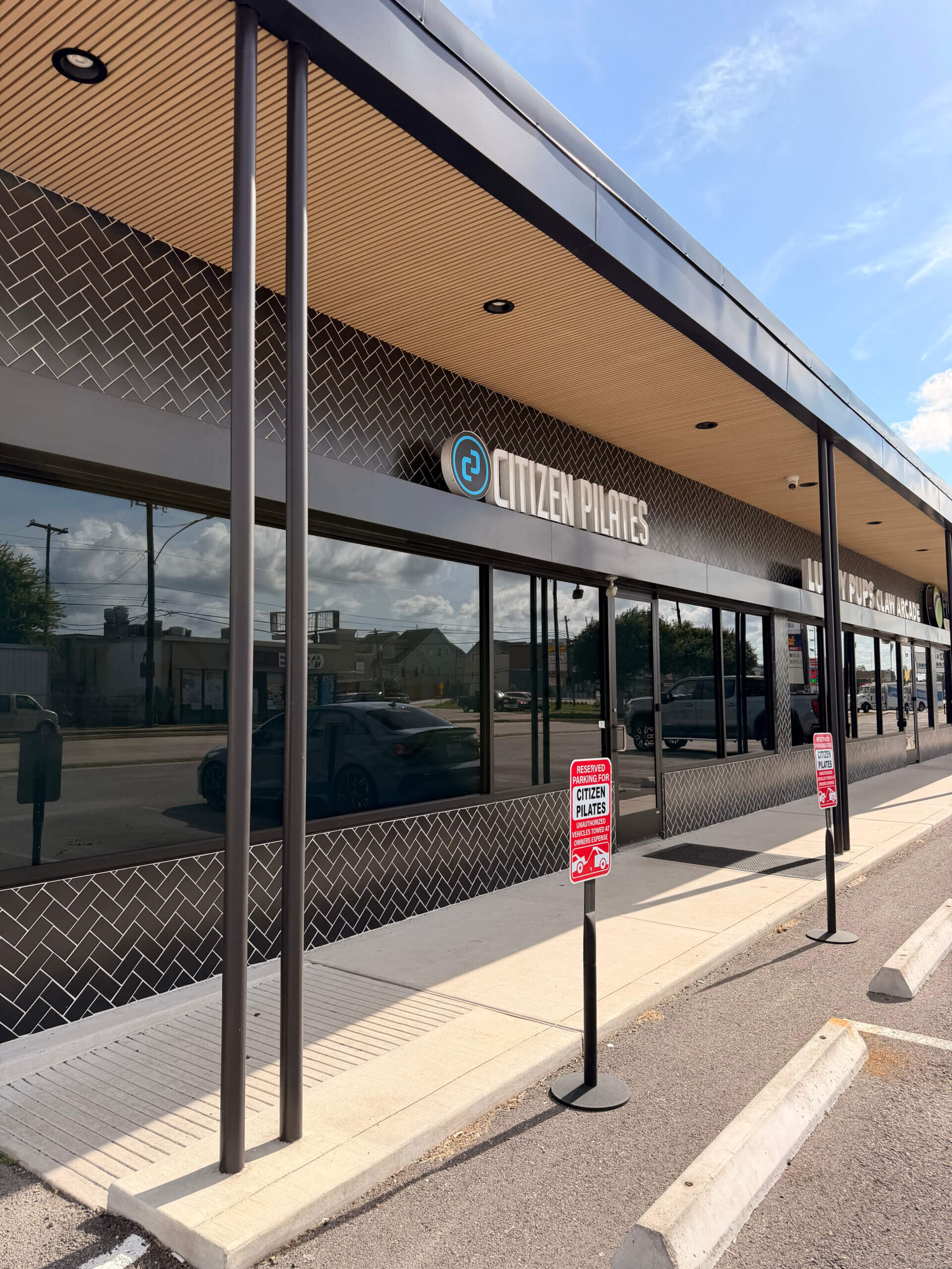 Exterior storefront of Citizen Pilates Spring Branch in Houston, featuring the studio's signage and entrance.