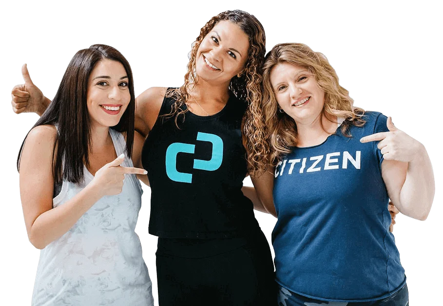 Three women posing for a picture in front of a black background.